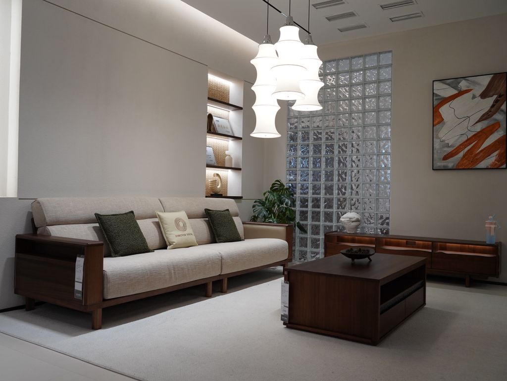 A contemporary living room featuring a minimalist design with wooden furniture and soft lighting.