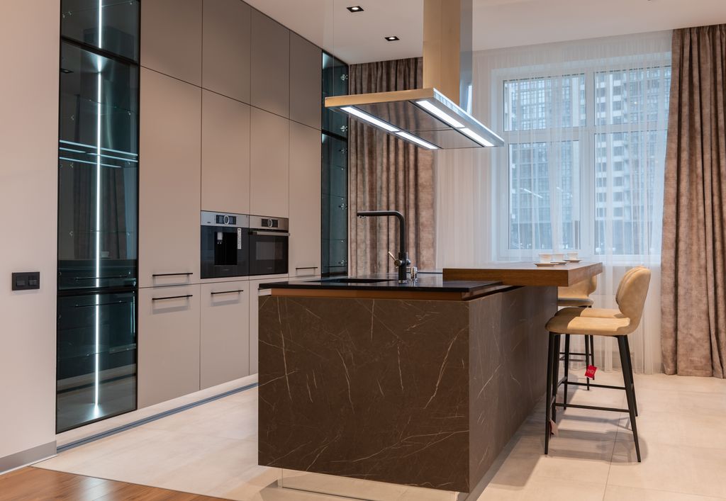 Light room interior with counter near chairs and window with curtains and kitchenware with cabinet