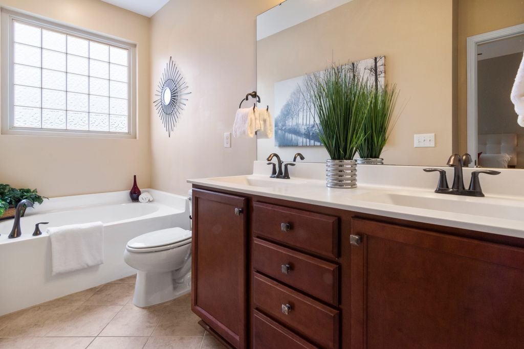 How to Paint Bathroom Cabinets for a Smooth, Lasting Finish Modern bathroom featuring a bathtub, sleek fixtures, and stylish decor.