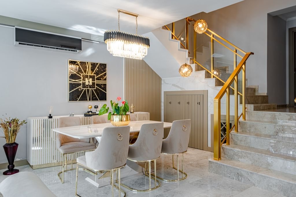 27 Modern Dining Room Ideas and Designs Modern dining room with marble table, gold accents, and stylish lighting.